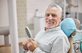 mature man happy after dental implant surgery 