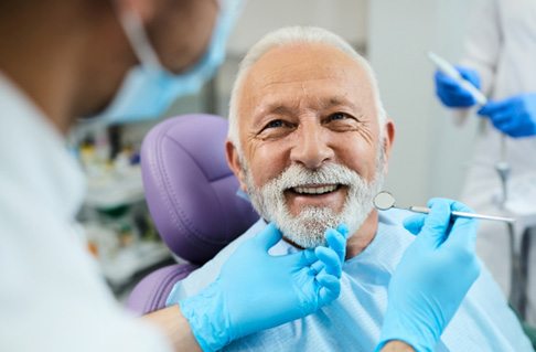 woman smiling after getting dental implants in Framingham