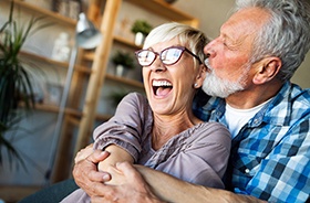 couple smiling while holding each other 