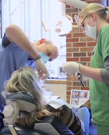 Dentist and team member providing dental treatment