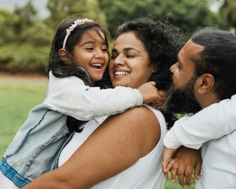 Family smiling together after preventive dentistry visit