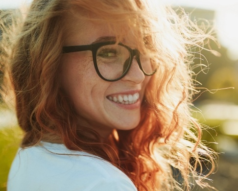 Woman sharing flawless smile after orthodontic treatment