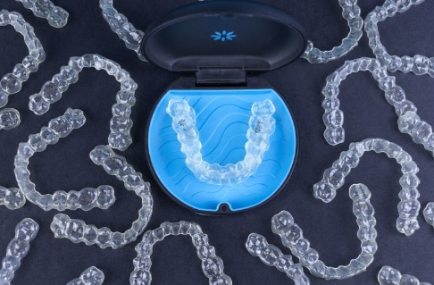 Sets of Invisalign clear aligners