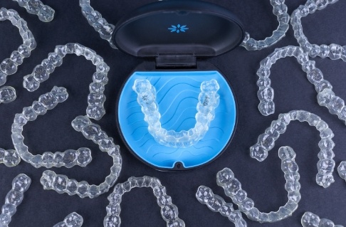Sets of Invisalign clear aligners