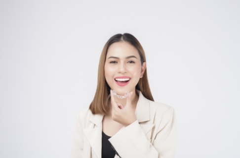 Woman placing a Clear Correct aligner