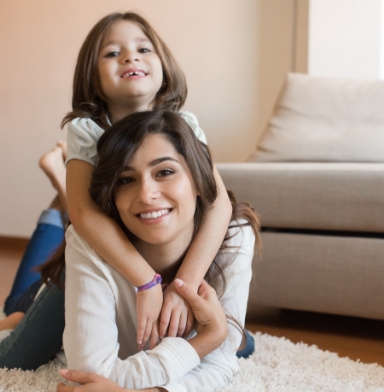 Mother and child with healthy smile after peventive dentistry