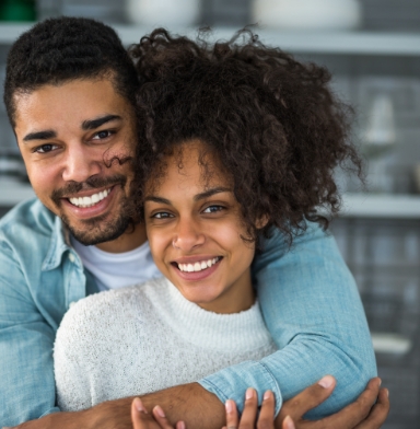 Couple with healthy smiles after restorative dentistry