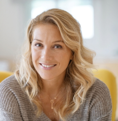 Woman smiling after sedation dentistry visit