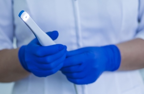 Dentist holding intraoral camera